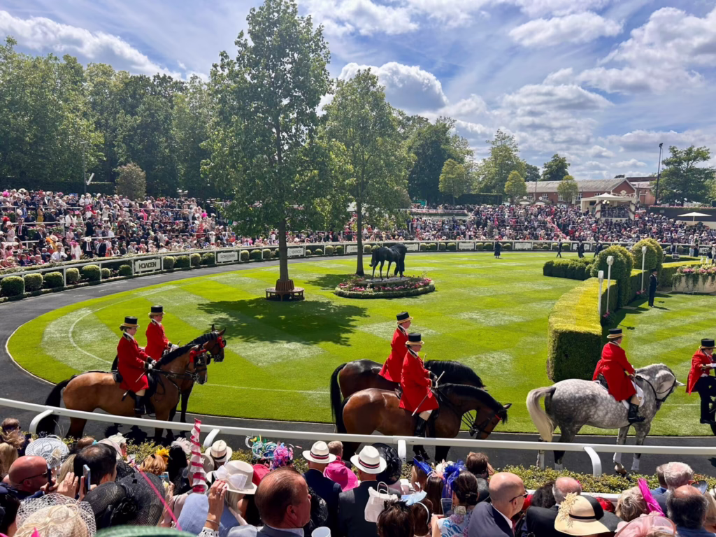 Horses and riders in a racecourse parade ring in England