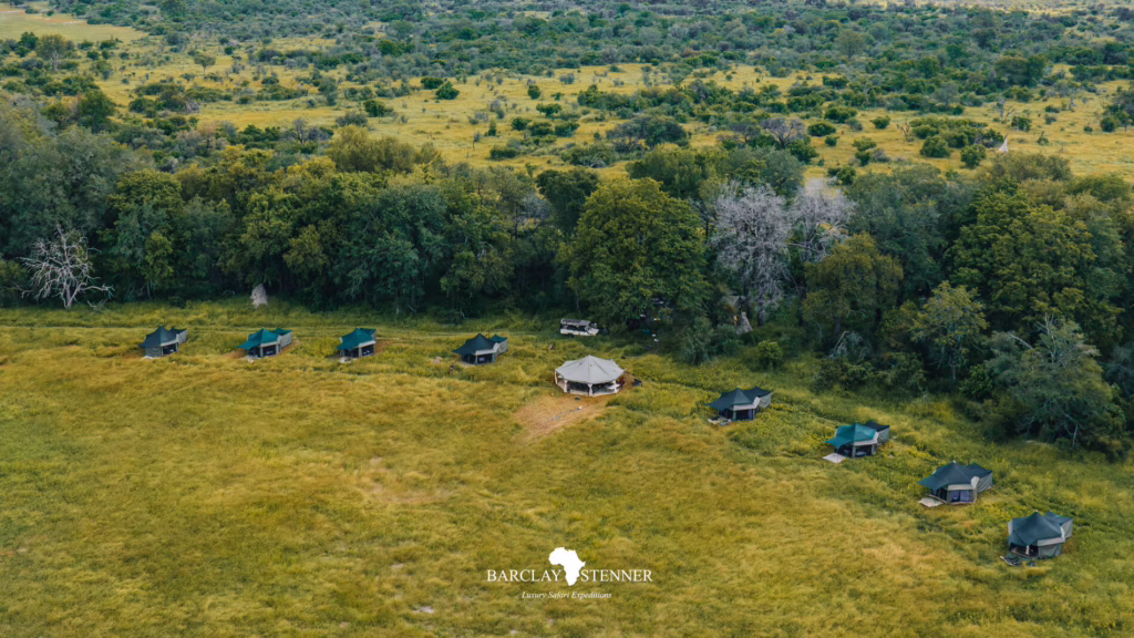 Aerial view of a Barclay Stenner Safaris tented camp beside woodland in Botswana
