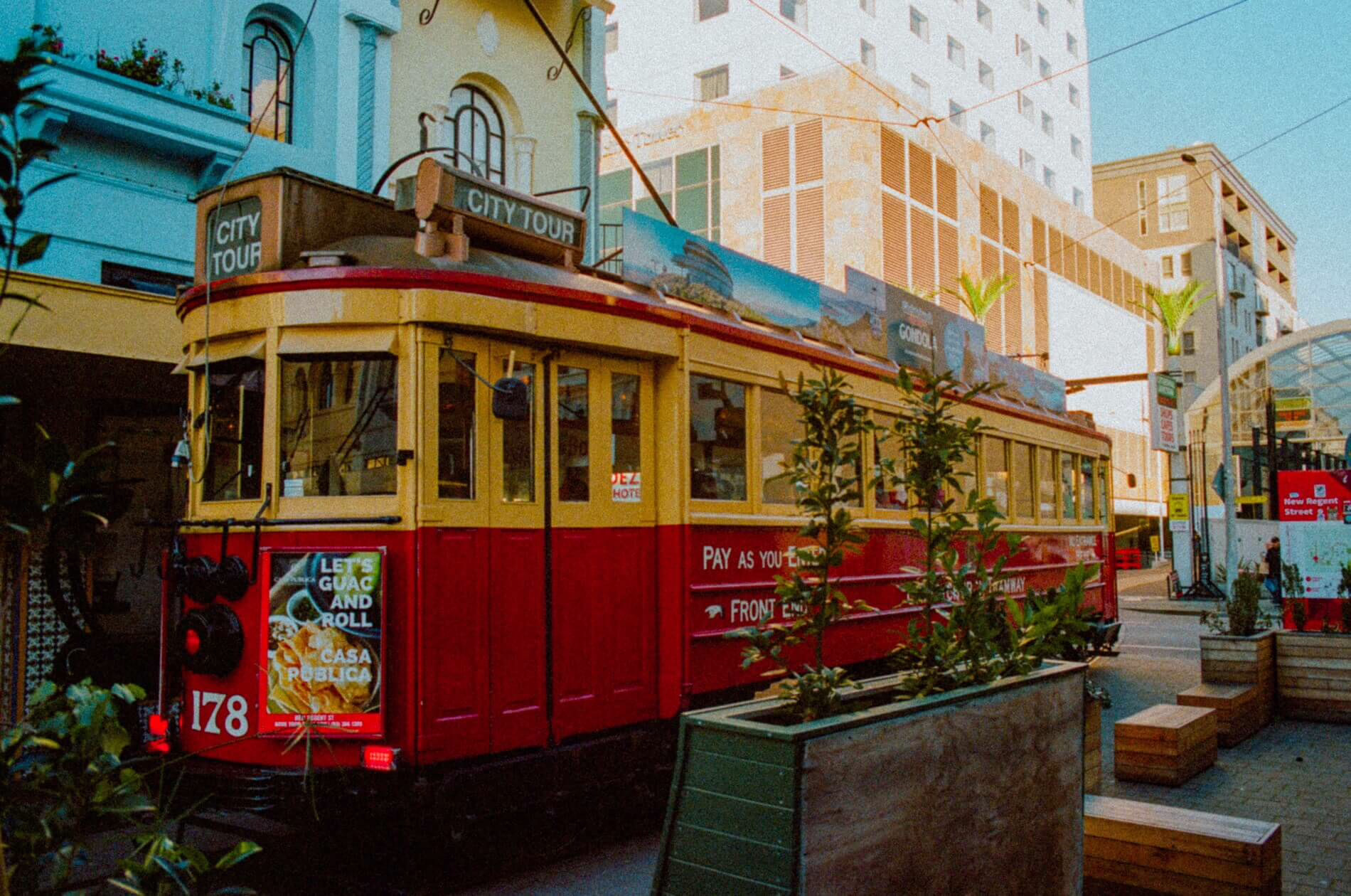 Historic red tram travelling through central Christchurch, New Zealand