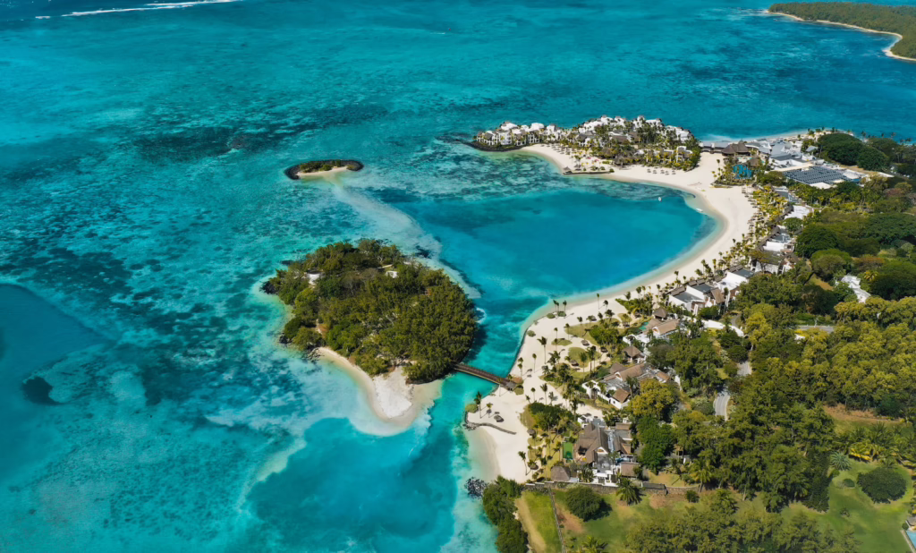 Aerial view of Shangri-La Le Touessrok beside a turquoise lagoon in Mauritius